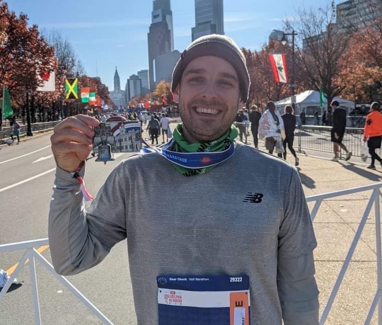 Mark holds up his first half marathon medal in Philadelphia